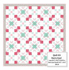 Carmon's Quilt Shop Starry-Eyed quilt kit featuring floral Northcott cotton fabrics in pink, green, and white.