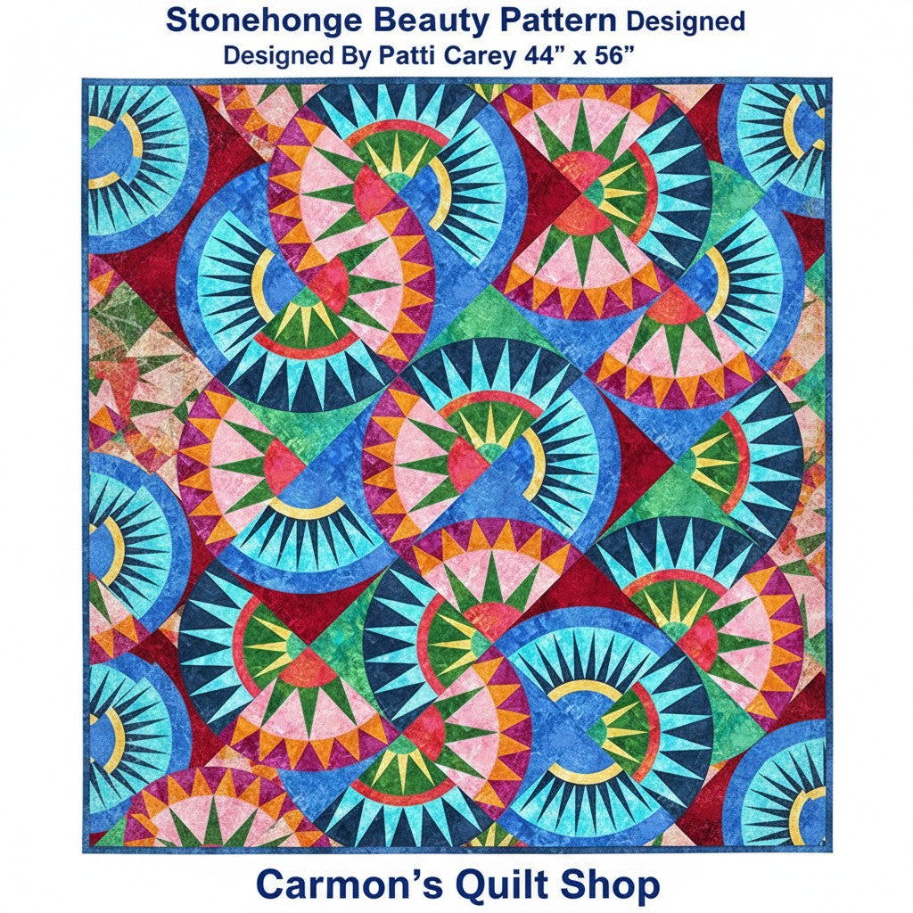 Carmon's Quilt Shop Stonehenge Beauty quilt featuring a vibrant paper-pieced star pattern in blue, red, and green tones.