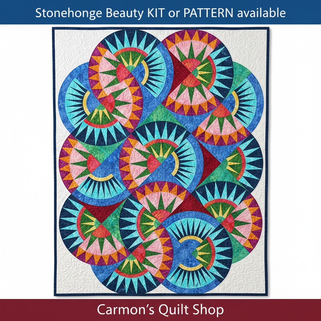 Carmon's Quilt Shop Stonehenge Beauty quilt featuring a vibrant paper-pieced star design in blue, green, and pink tones.