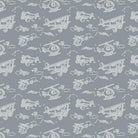 Carmon's Quilt Shop Sweet Dreams baby quilt kit fabric with white line drawings of biplanes, helicopters, and clouds on a grey background. 100% cotton.