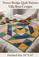 Carmon's Quilt Shop Tower Bridge quilt pattern featuring a colorful geometric diamond design on a bed.