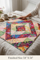 Carmon's Quilt Shop Tower Bridge quilt pattern featuring a colorful central diamond design on a square throw quilt.