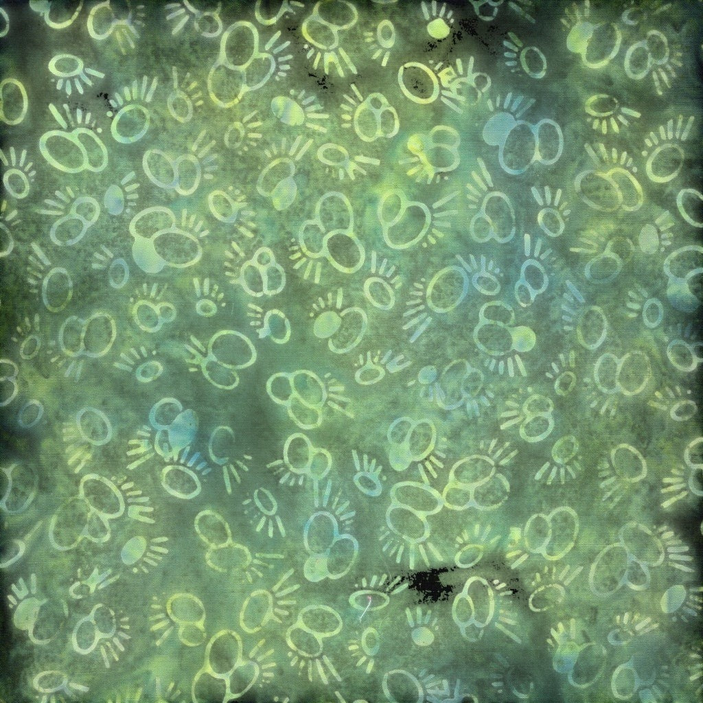 Carmon's Quilt Shop Vintner's Treasure Island Batik fabric in green and purple with a whimsical circular pattern.