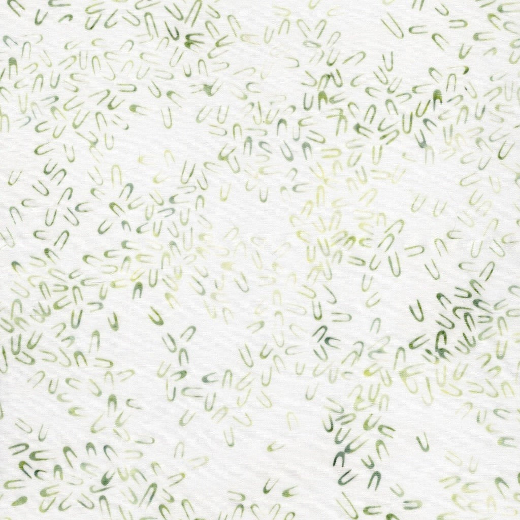 Carmon's Quilt Shop Vintner's Treasure batik fabric featuring a white background with small green U-shaped motifs.