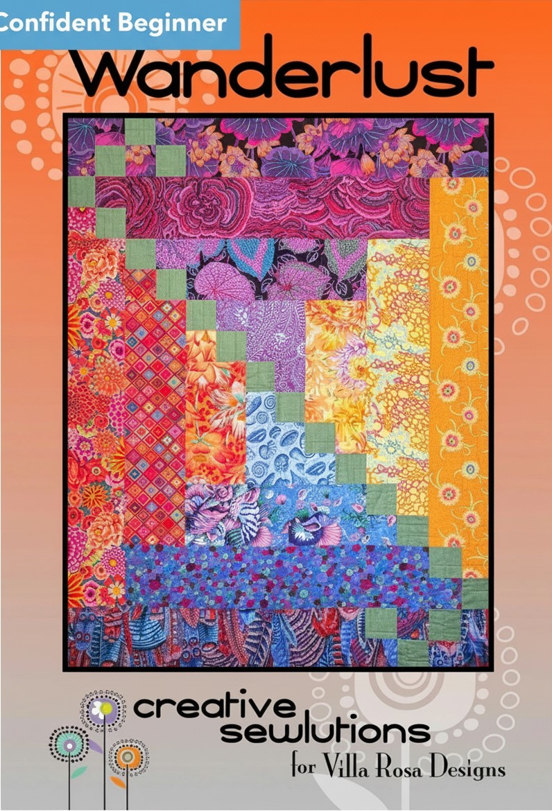 Carmon's Quilt Shop Wanderlust quilt pattern featuring a modern Courthouse Steps design with vibrant floral fabrics.